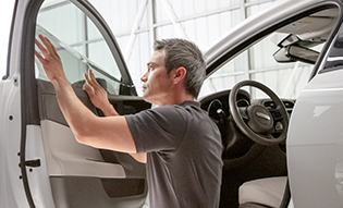 LLumar dealer installing window film on car 